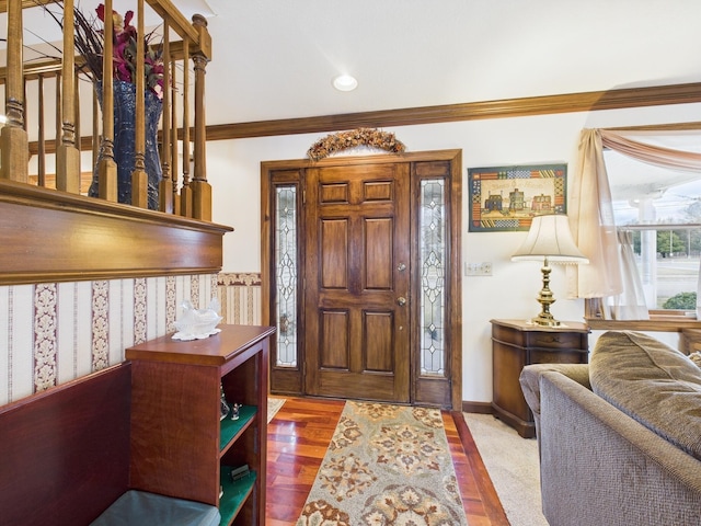 foyer entrance with wood finished floors, baseboards, ornamental molding, and recessed lighting