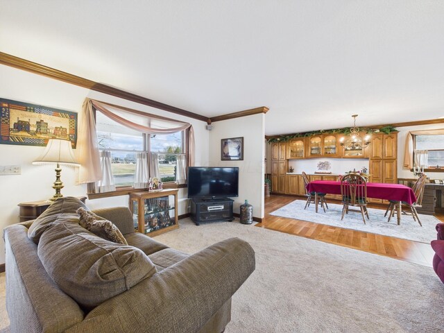 living room with light wood finished floors, light colored carpet, baseboards, and ornamental molding