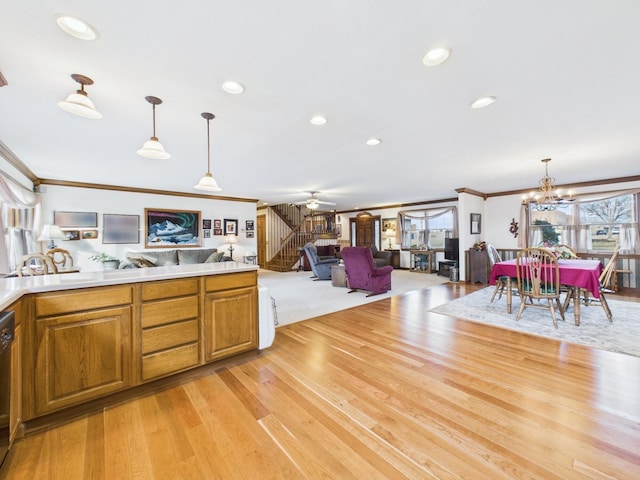 kitchen with decorative light fixtures, dishwasher, light wood-type flooring, ornamental molding, and brown cabinets