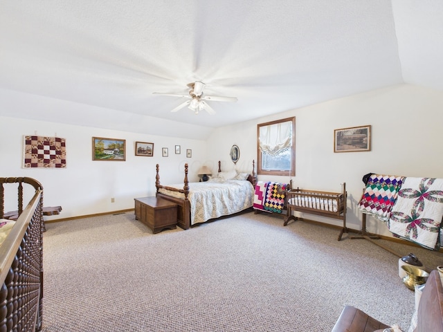 carpeted bedroom featuring baseboards, ceiling fan, and vaulted ceiling