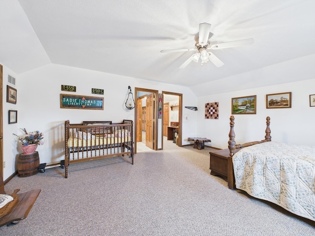 carpeted bedroom with lofted ceiling, baseboards, visible vents, and ceiling fan