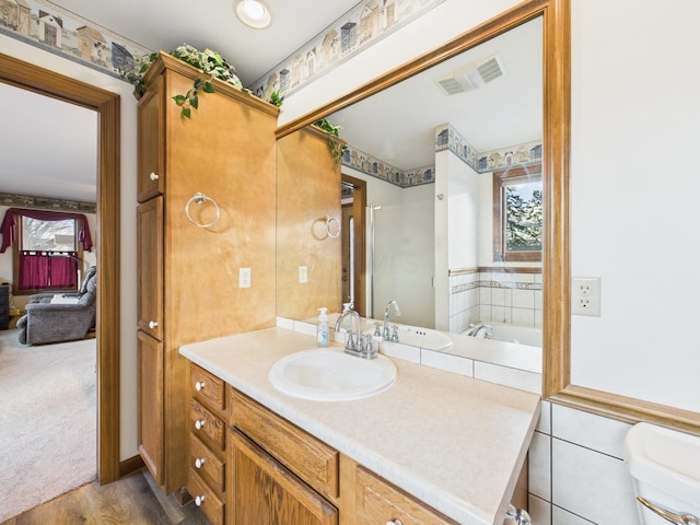 full bathroom featuring visible vents, toilet, vanity, and wood finished floors