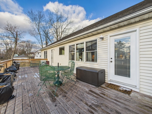 wooden terrace with cooling unit and outdoor dining space