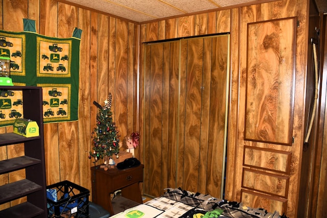 bedroom featuring wood walls