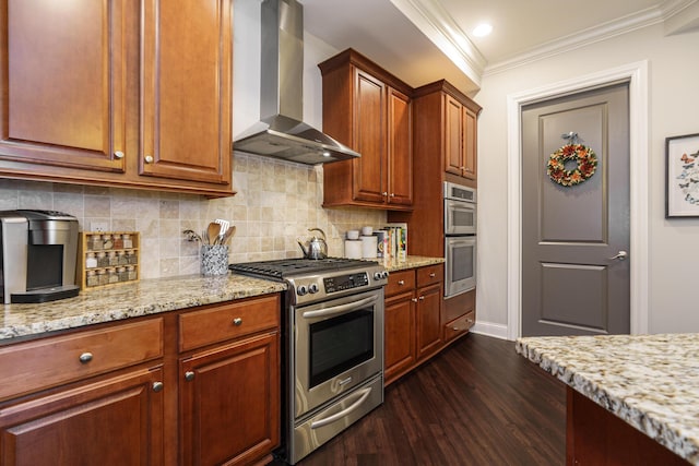 kitchen with decorative backsplash, dark wood-type flooring, appliances with stainless steel finishes, crown molding, and wall chimney exhaust hood