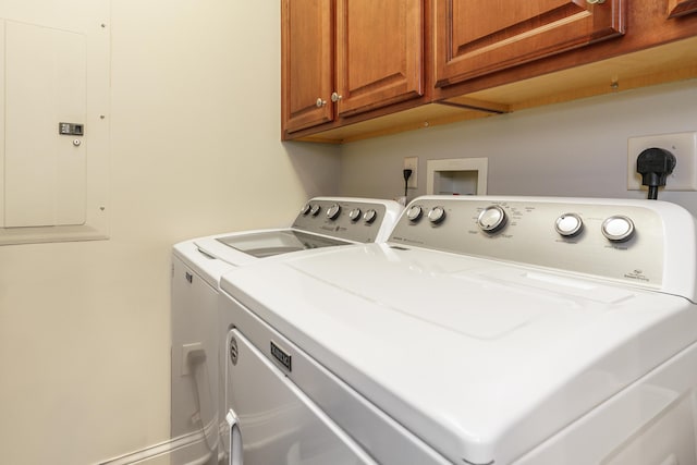 laundry area with washer and dryer, cabinet space, and electric panel