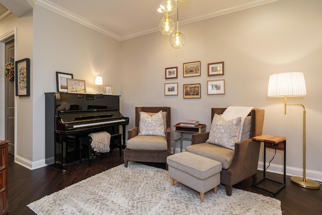 living area featuring baseboards, wood finished floors, and crown molding