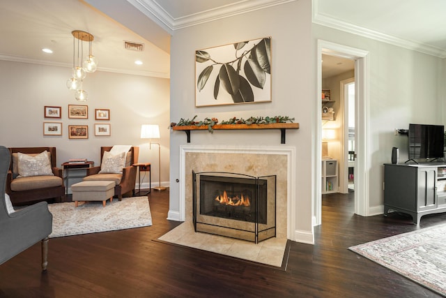 living area featuring a high end fireplace, visible vents, baseboards, ornamental molding, and wood finished floors