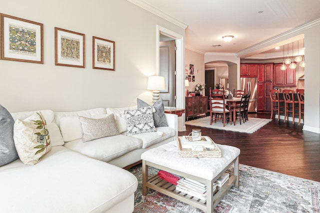 living area featuring crown molding, visible vents, arched walkways, and dark wood-type flooring