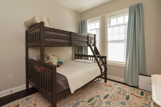 bedroom featuring wood finished floors and baseboards