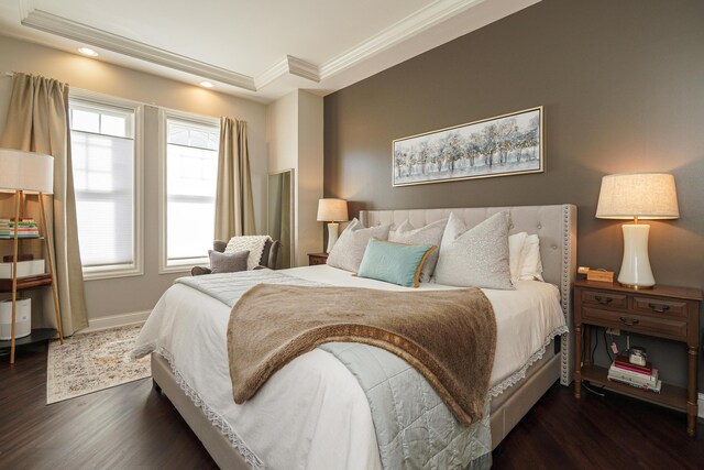 bedroom with dark wood finished floors, crown molding, recessed lighting, and baseboards