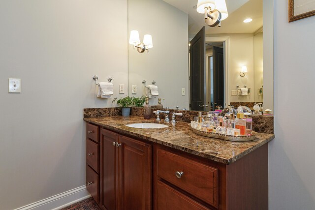 bathroom with vanity and baseboards