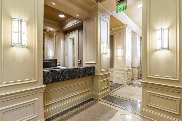 bathroom with recessed lighting, decorative columns, crown molding, and a decorative wall