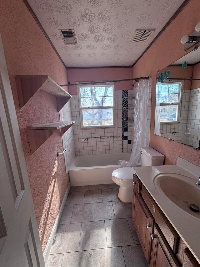 bathroom with visible vents, a healthy amount of sunlight, a textured ceiling, and toilet