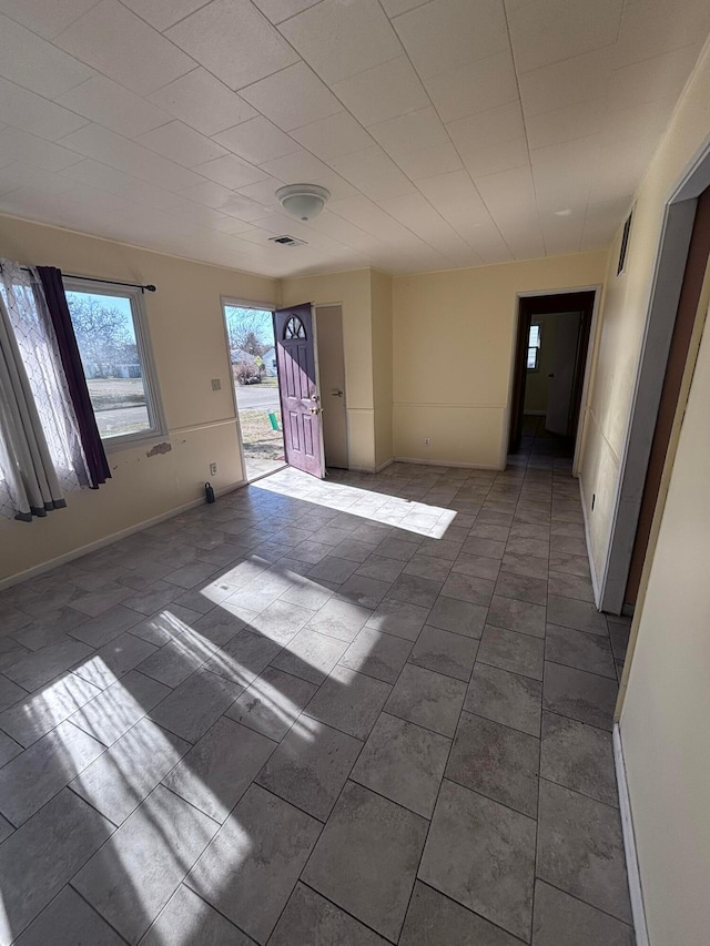 interior space featuring baseboards and visible vents