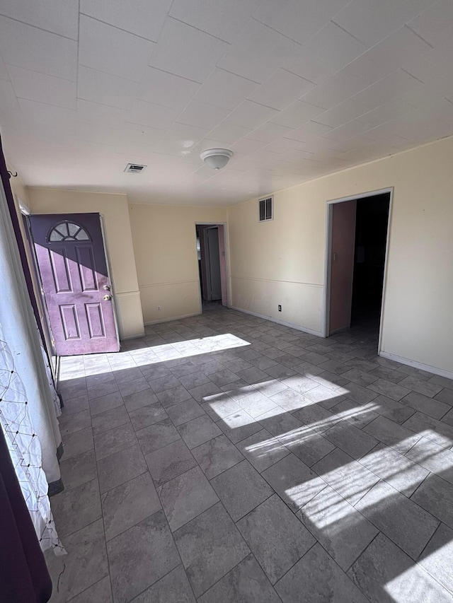 empty room with visible vents and baseboards