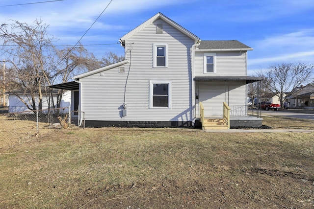 back of property with fence and a lawn