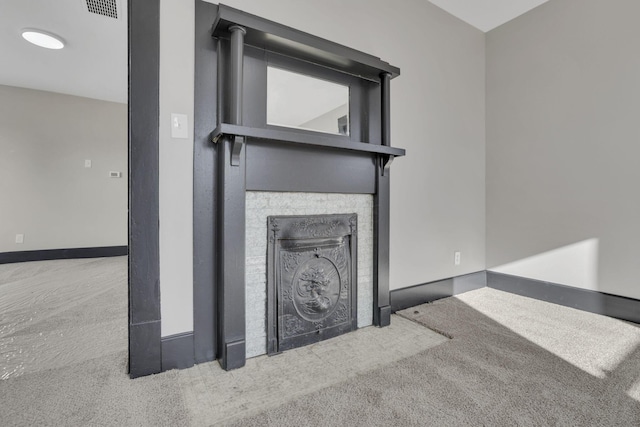 interior details featuring visible vents, baseboards, carpet, and a fireplace