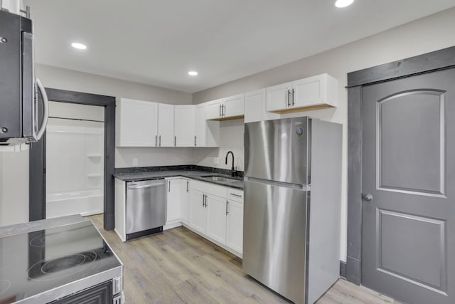 kitchen featuring a sink, white cabinetry, and stainless steel appliances