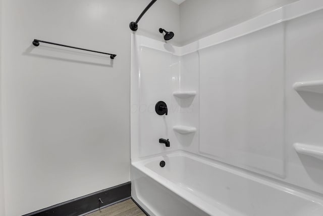 full bathroom with wood finished floors and baseboards