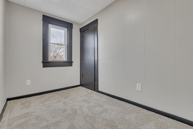 empty room with baseboards and carpet flooring