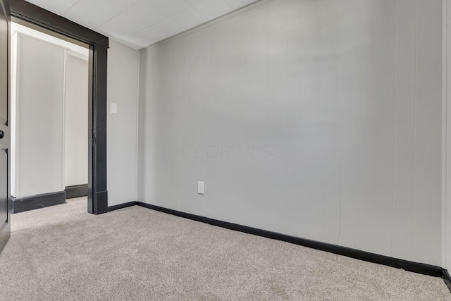 unfurnished room featuring carpet flooring and baseboards