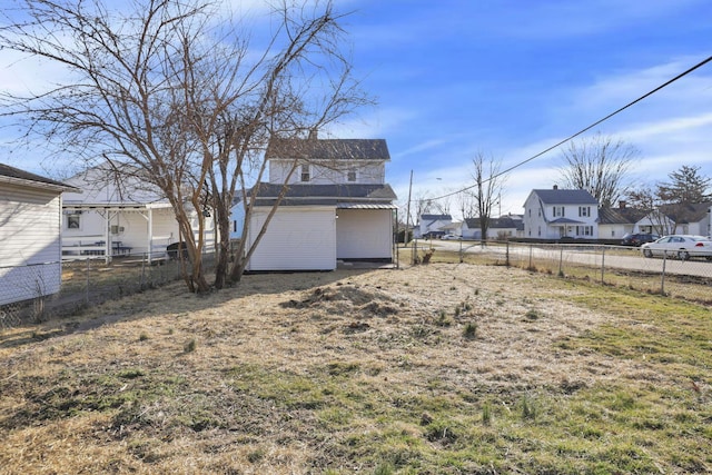 view of yard featuring a residential view and fence