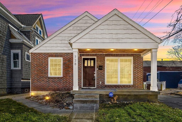 view of front of property with brick siding and a porch