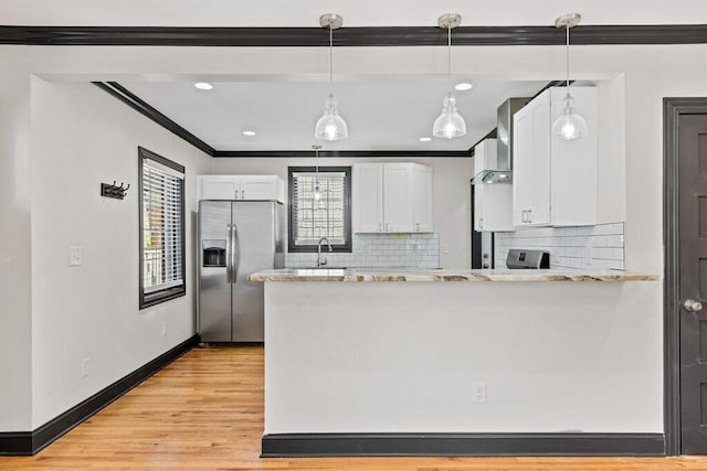 kitchen featuring stainless steel fridge, white cabinets, crown molding, and light wood-style floors