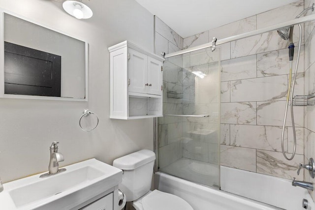 full bathroom featuring shower / bath combination with glass door, vanity, and toilet