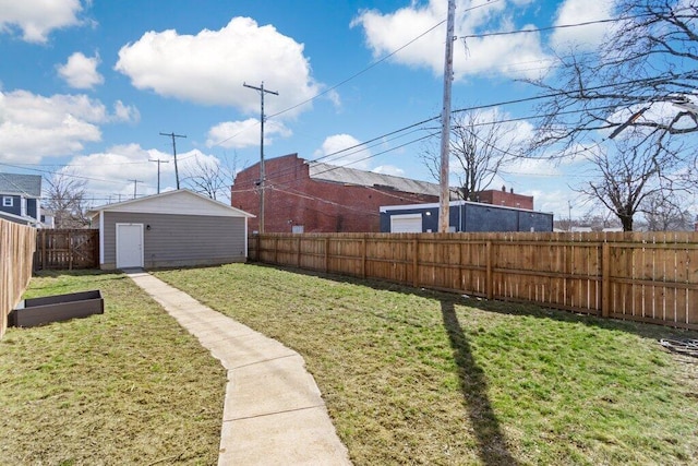 view of yard with a fenced backyard, a storage unit, and an outdoor structure