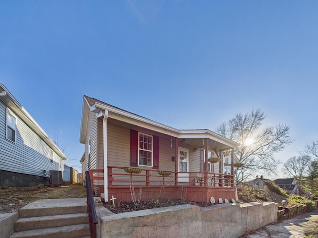 view of front facade with a porch and cooling unit