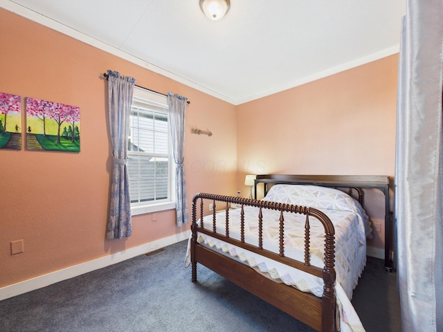 carpeted bedroom with visible vents, baseboards, and crown molding