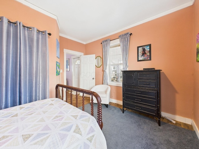 bedroom with crown molding, baseboards, and dark wood-style flooring