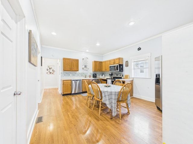 kitchen featuring decorative backsplash, light countertops, visible vents, and stainless steel appliances