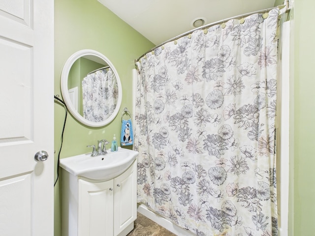 bathroom featuring curtained shower and vanity