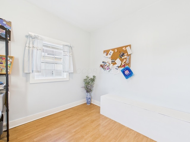 unfurnished room featuring wood finished floors and baseboards