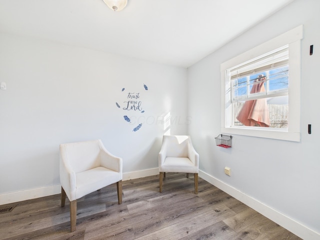 living area with wood finished floors and baseboards