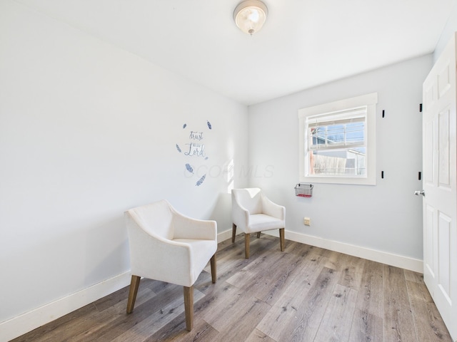 living area featuring baseboards and wood finished floors