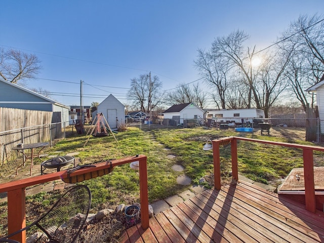 wooden terrace with a fenced backyard and a lawn