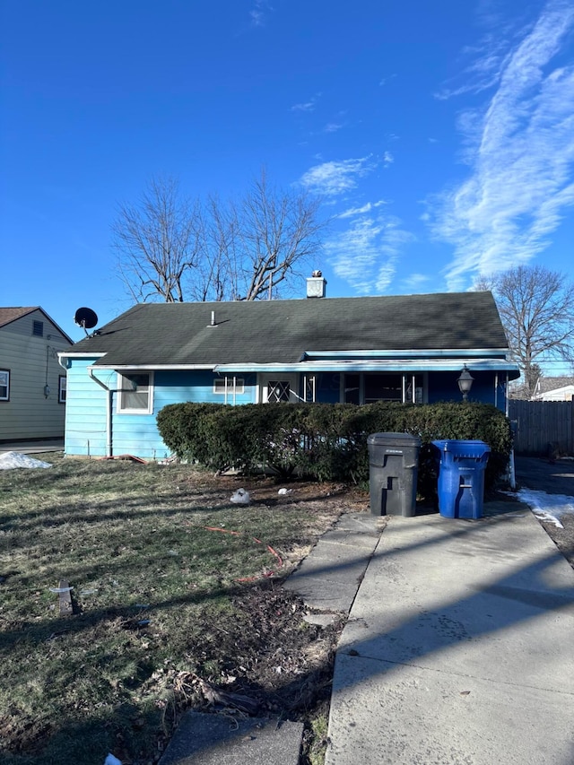 view of front of home featuring fence and a chimney