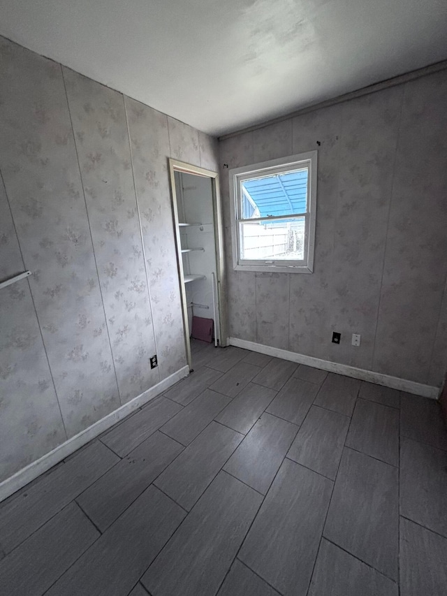 unfurnished bedroom featuring wood finish floors and baseboards