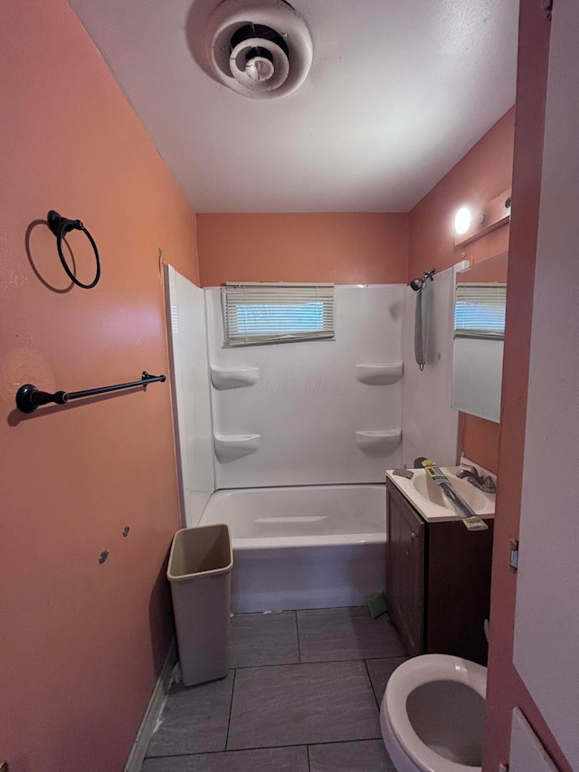 bathroom with vanity, toilet, a healthy amount of sunlight, and shower / washtub combination