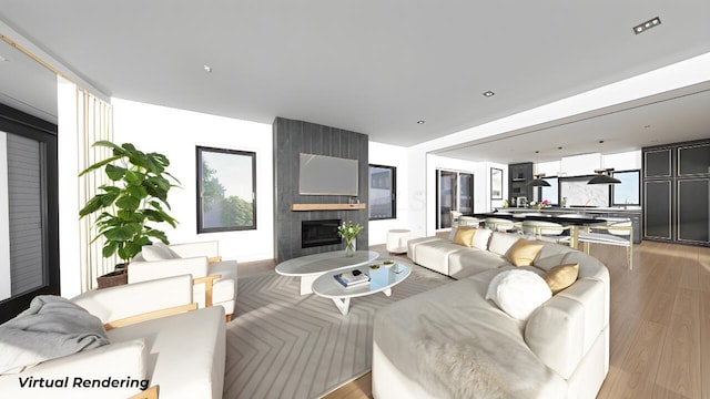 living area featuring light wood-type flooring and a fireplace