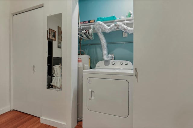 laundry area with washer / dryer, wood finished floors, baseboards, and laundry area