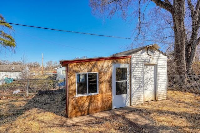 view of outdoor structure with an outbuilding and fence