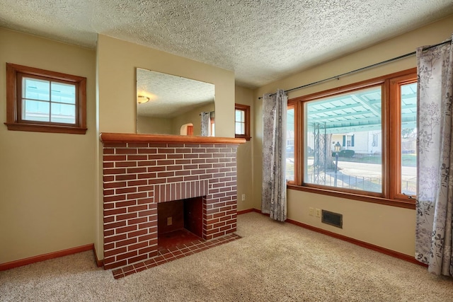 unfurnished living room featuring carpet flooring, visible vents, and a wealth of natural light