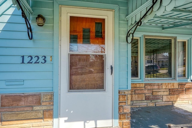 doorway to property featuring stone siding