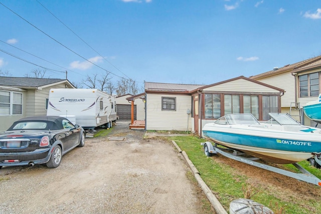 exterior space featuring driveway and metal roof