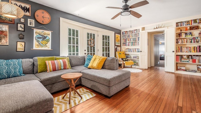 living room featuring built in features, french doors, ceiling fan, and hardwood / wood-style floors